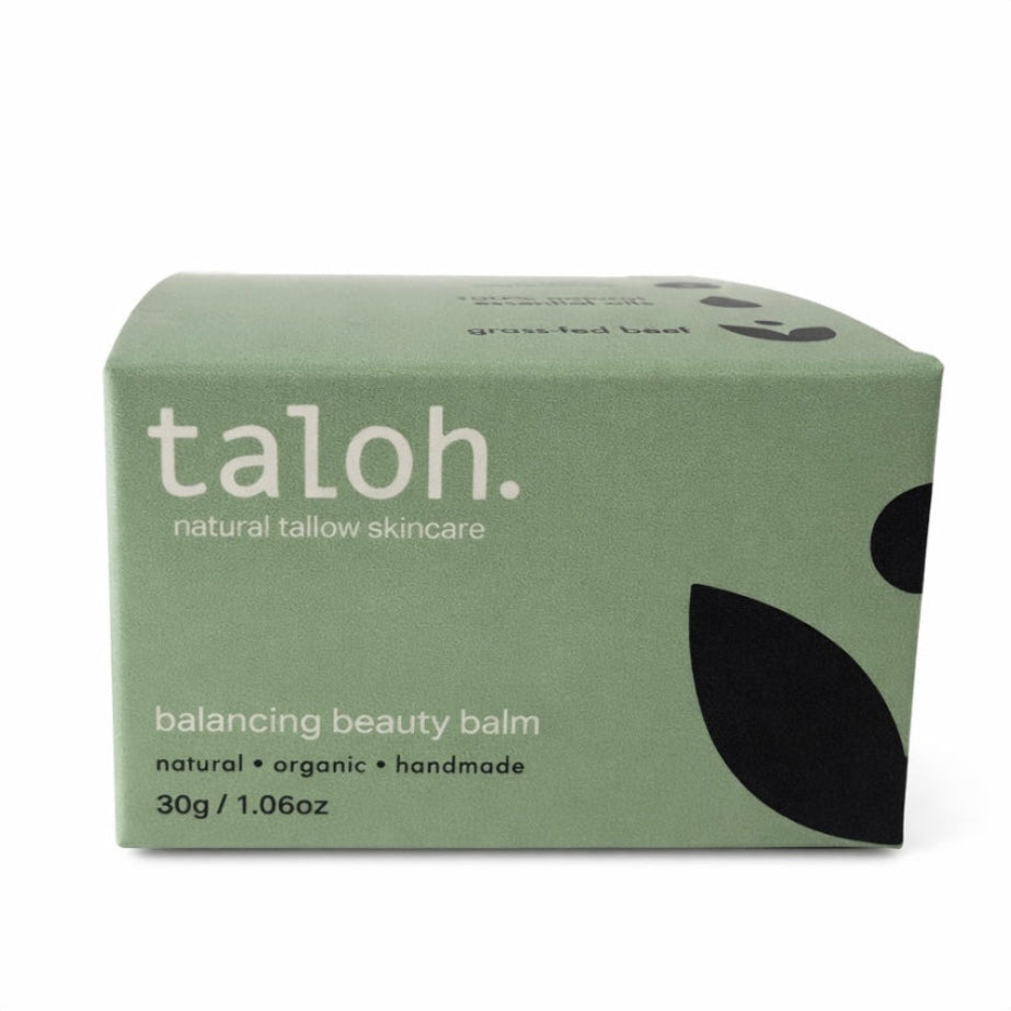 Green box of taloh balancing beauty balm in a glass jar made from 100% grass-fed beef tallow on a white background