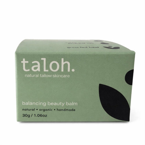Green box of taloh balancing beauty balm in a glass jar made from 100% grass-fed beef tallow on a white background