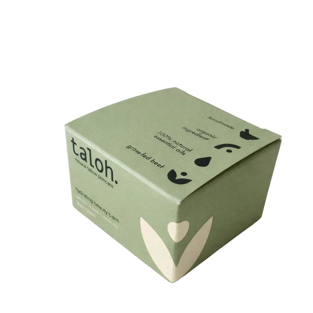 Green box of 100% grass-fed beef tallow based hydrating beauty balm with a cream leaf and ingedient icons on it.