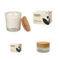 Taloh natural soy candle, jar, and boxes of 100% grass-fedtallow beef based skincare on a white background