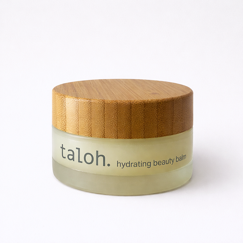 Glass jar of taloh hydrating beauty balm with a wooden lid on a white background