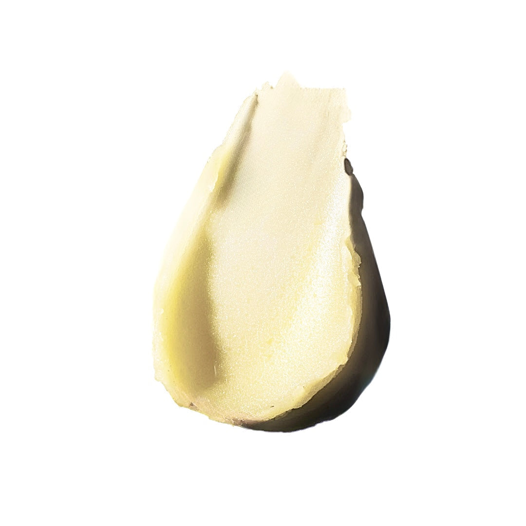 Close-up of a smear of Bedtime Balm light-colored beef tallow balm on a white background